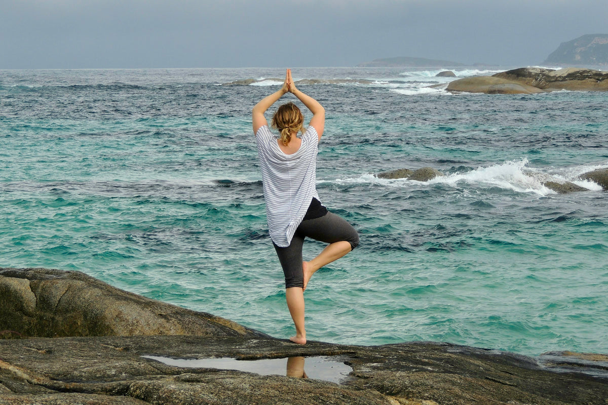 Yoga on the rocks by the sea