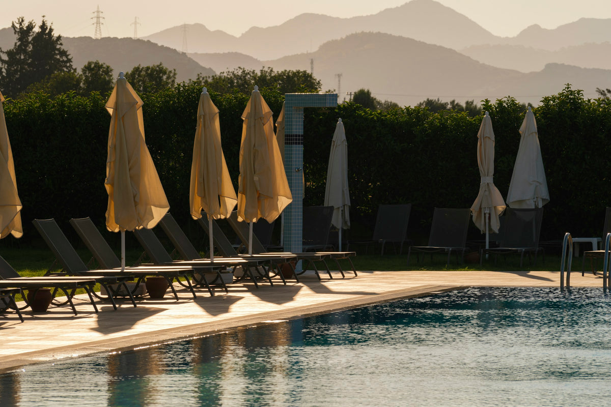 Fringed parasols by the pool at golden hour, Manipura retreat