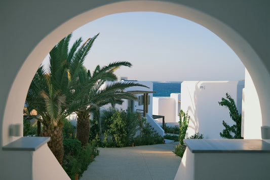 Whitewashed arch framing the sea, Sahasrara retreat